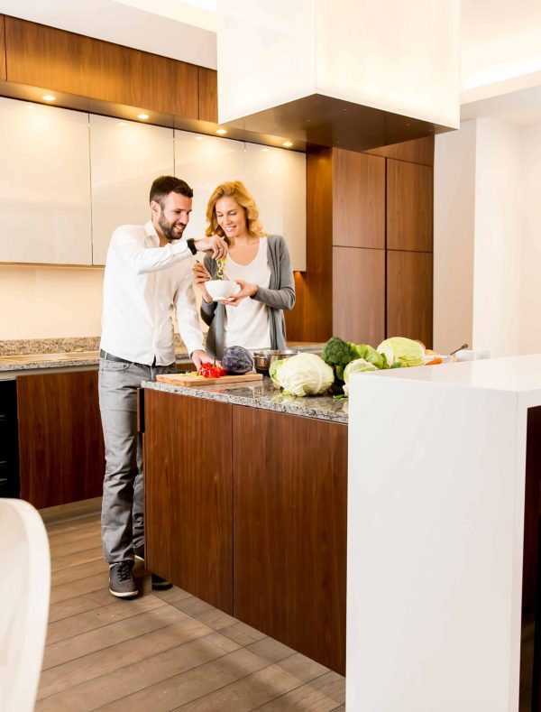 Loving couple preparing food in the modern kitchen